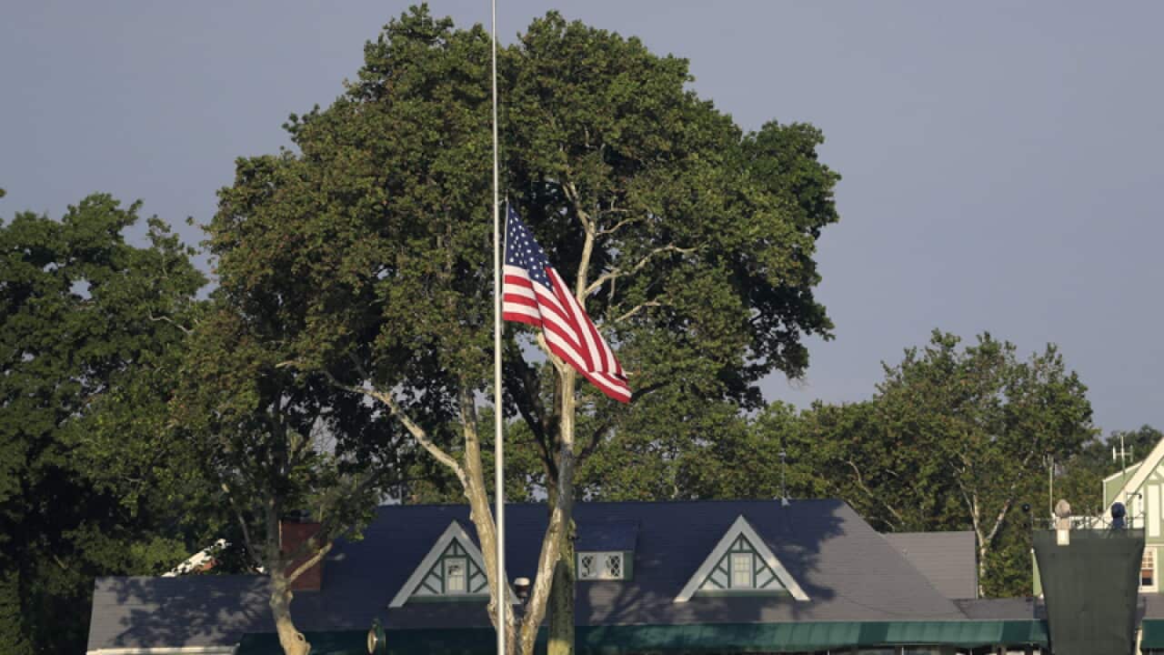 The US flag flies at half mast near the ninth green
