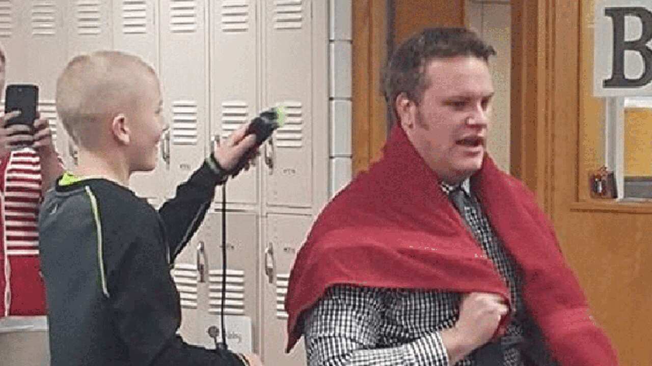Teacher shaves head in solidarity with student