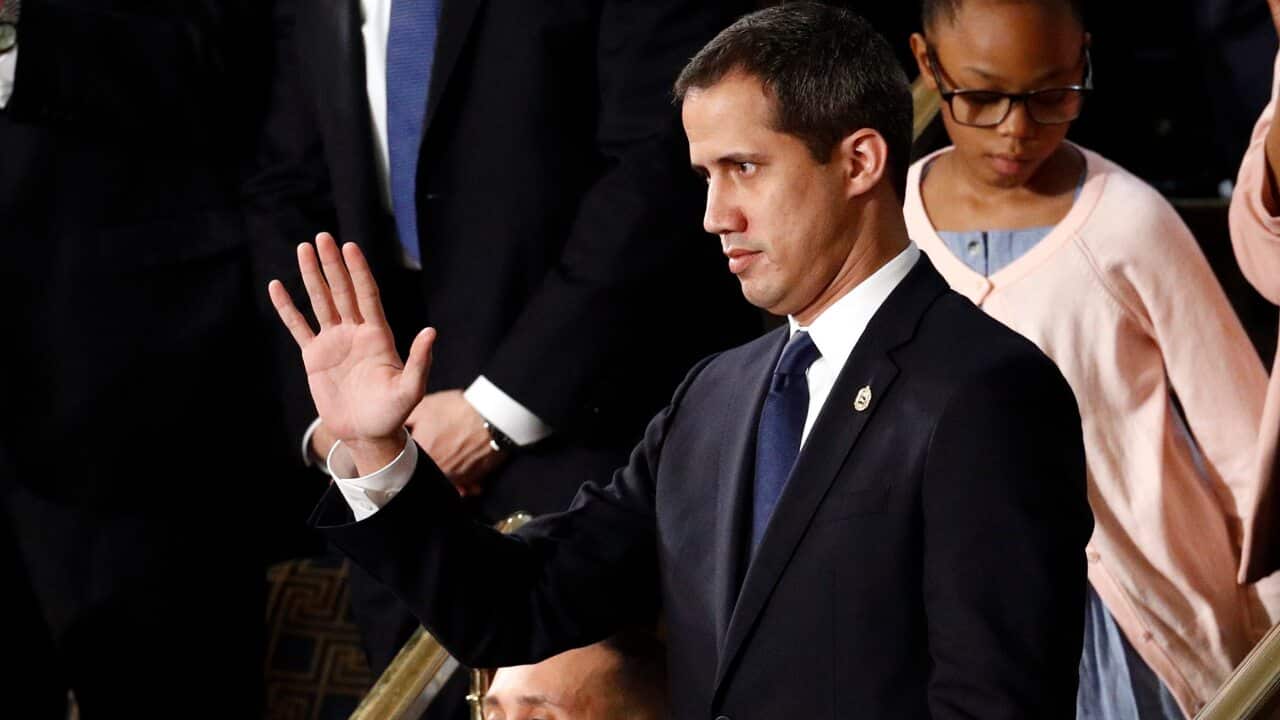 Venezuelan opposition leader Juan Guaido waves as President Trump delivers his State of the Union address.