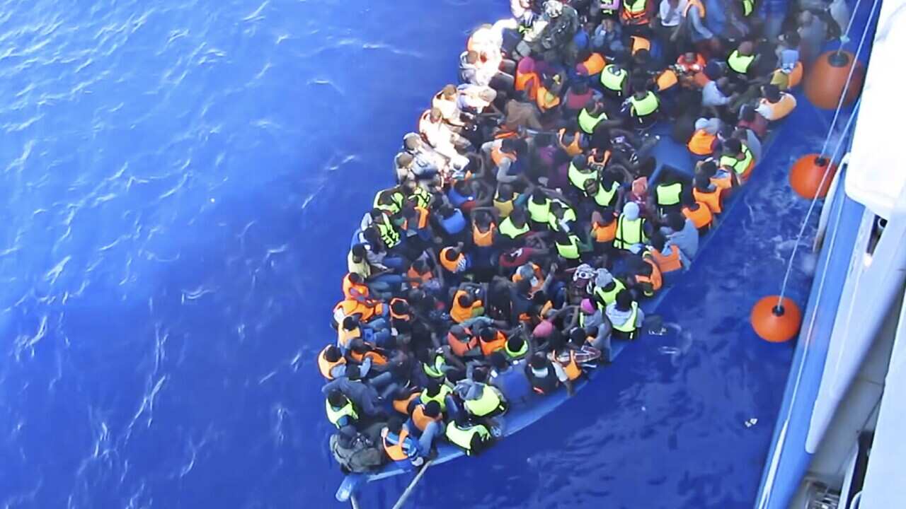 In this photo provided by the Swedish Coast Guard, migrants are boarding the ship Poseidon after being spotted in a fishing boat off the Libyan coast Wednesday, Aug. 26, 2015. (Swedish Coast Guard via AP Photo)