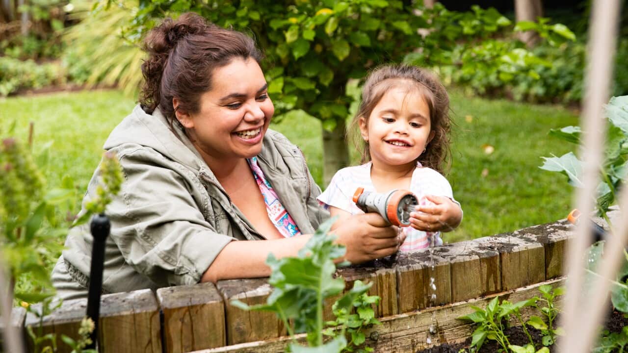 Happy gardening time with mother and toddler