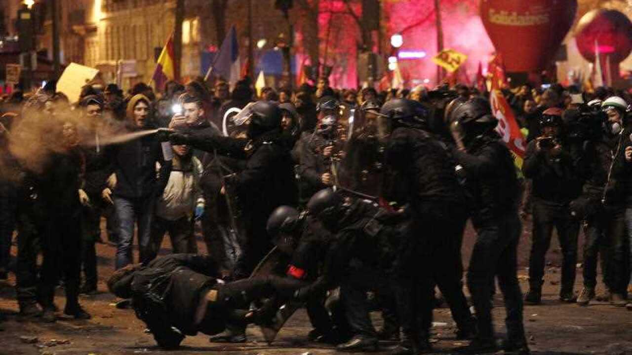 French riot police clash with protesters during a demonstration against pension reforms in Paris, France, 5 December 2019