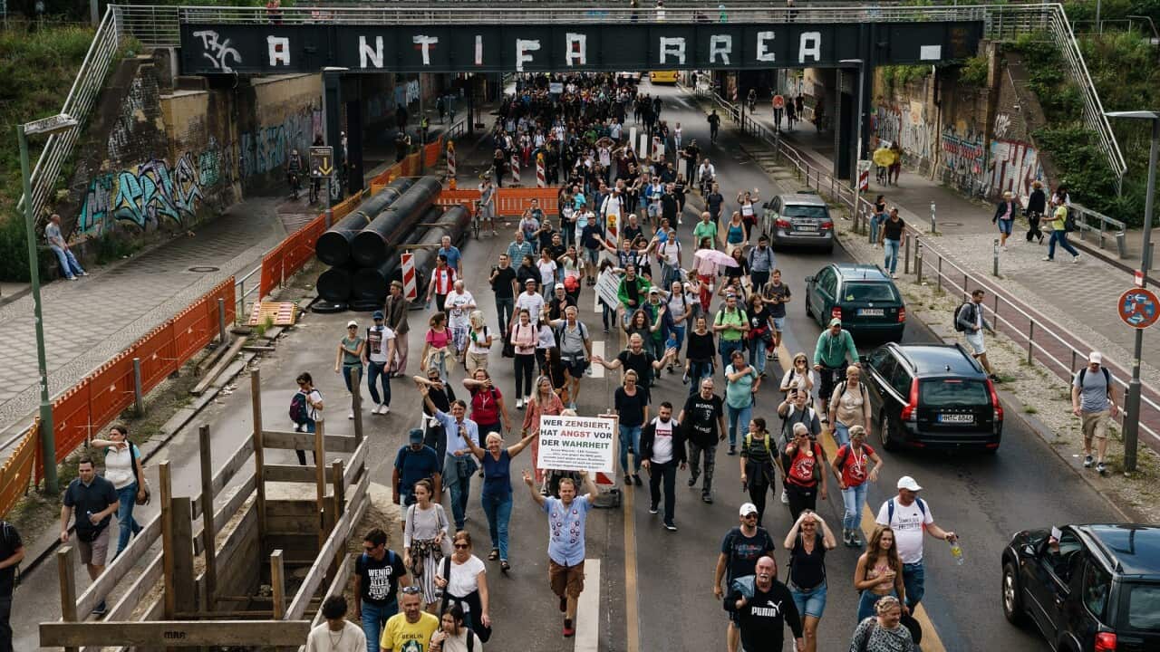 Demonstrators march on Berlin's streets during an unauthorized protest against the coronavirus measures