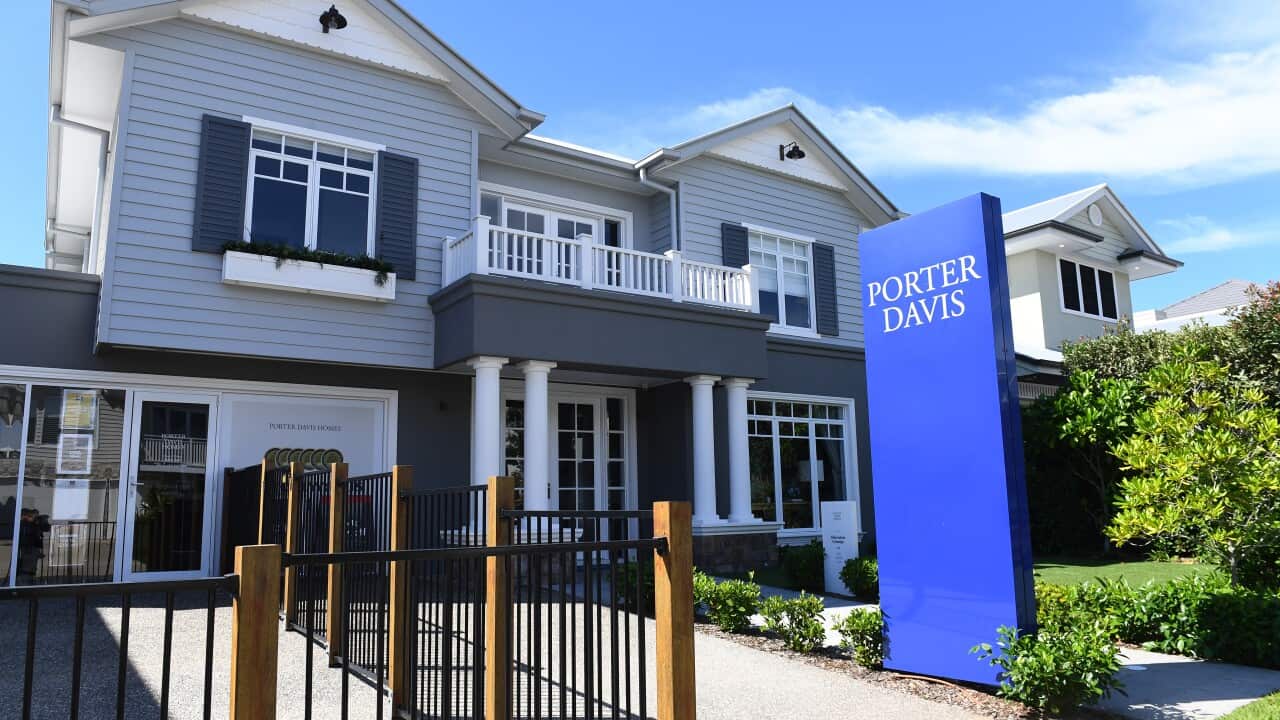 A white, blue and grey display home with a bright blue sign reading, Porter Davis at the front.