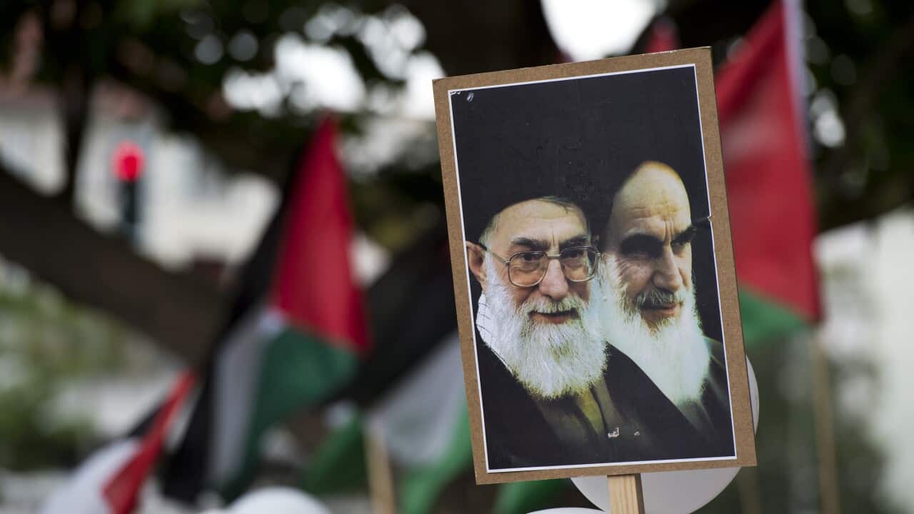A placard featuring portraits of Iranian supreme leader Ali Khamenei (left) and former supreme leader Ayatollah Khomeini.