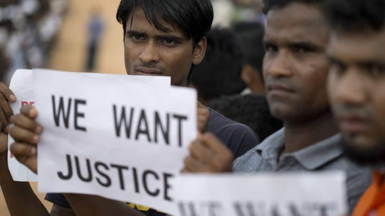Rohingya refugees holing placards