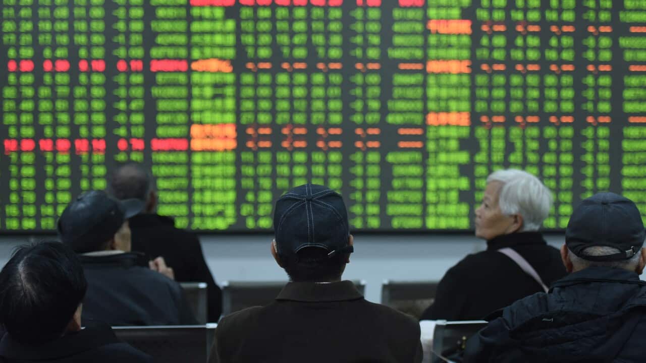 Stock investors sit in front of a display screen at a brokerage house in Hangzhou, Zhejiany province, China, 03 February 2020.