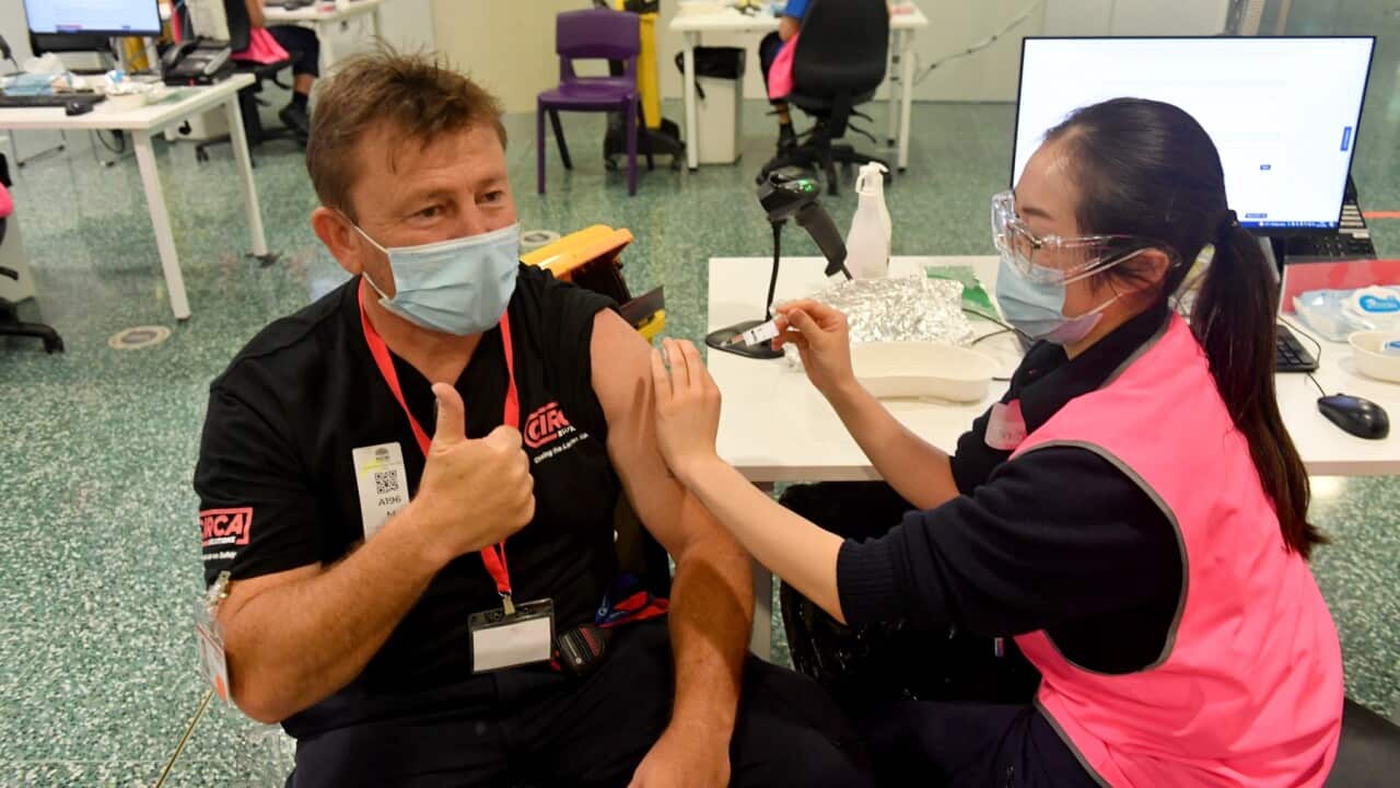 A member of the public gets his booster Pfizer vaccine at Qudos Bank Arena Vaccination Centre before it closes in Sydney (AAP)