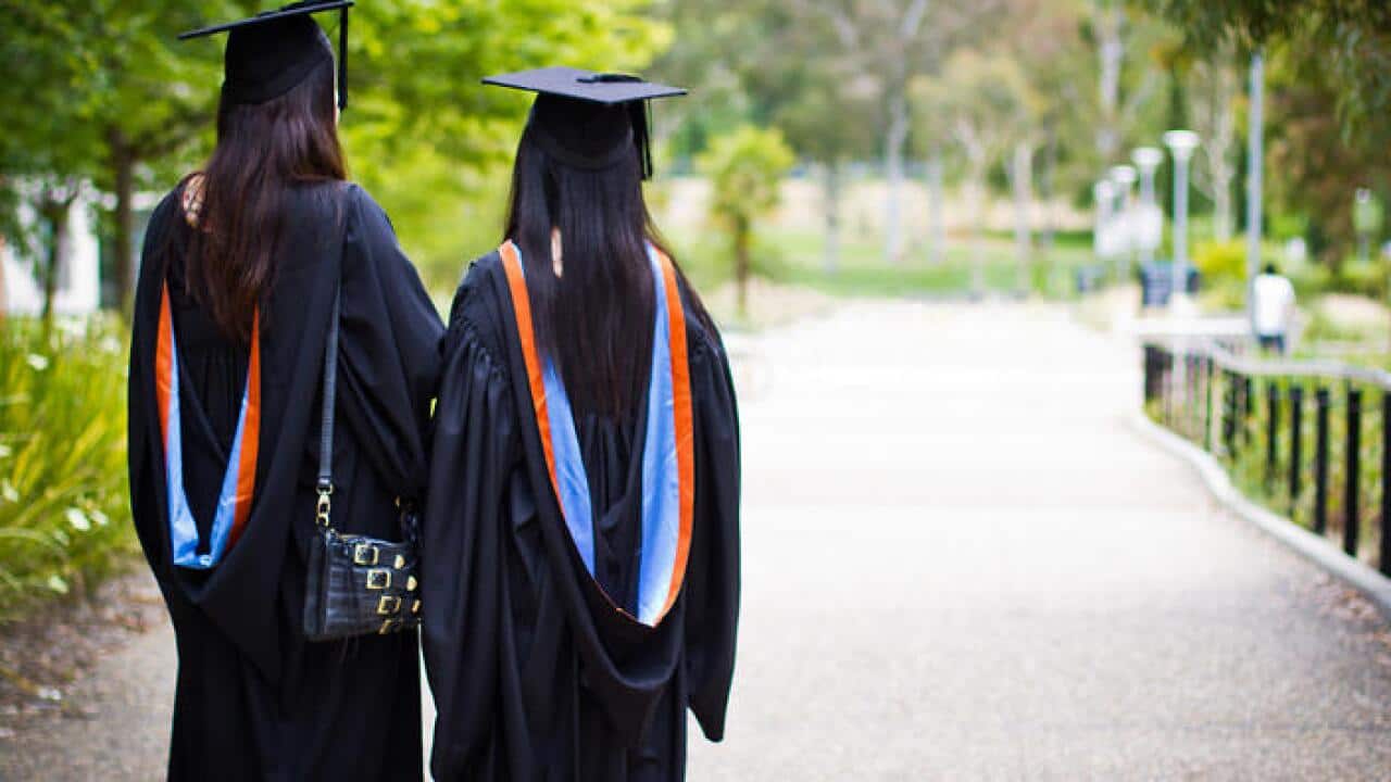 Two international student graduates at the Australian National University in Canberra