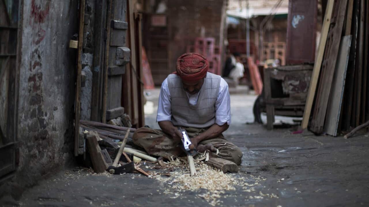 A Yemeni carpenter works in front of his shop at a market in the old city of Sanaa, Yemen, Saturday, Nov. 19, 2016.