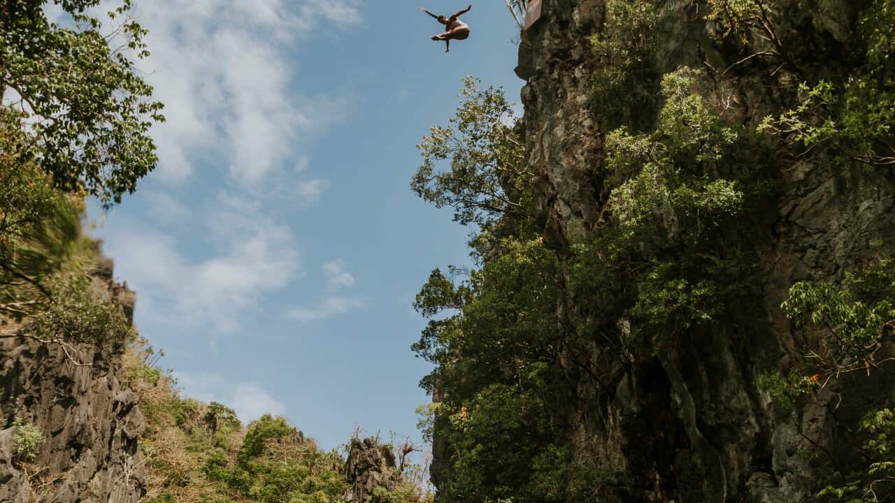 Xantheia Pennisi of Australia dives from a rock pinnacle at the Small Lagoon on Miniloc Island during the second training session of the first stop of the Red Bull Cliff Diving World Series in Palawan, Philippines on April 11, 2019.