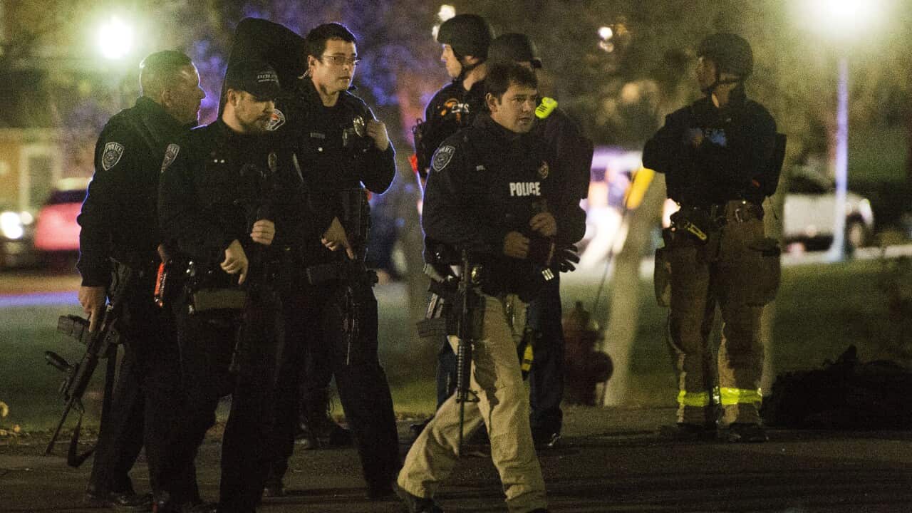 Police officers search for a gunman near Red Butte Garden on the University of Utah campus in Salt Lake City, Monday, Oct. 30, 2017. Police say a deadly shooting occurred near the school campus on Monday. (Rick Egan/The Salt Lake Tribune via AP)