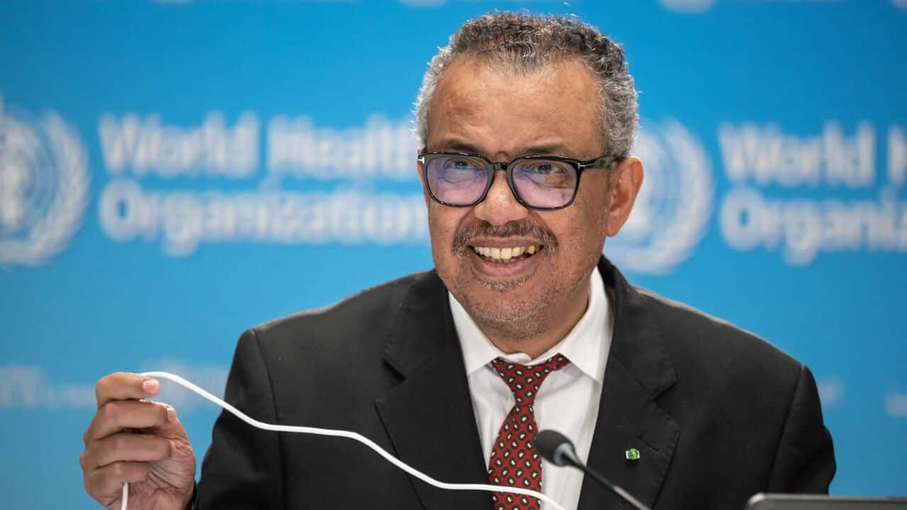 A man smiling wearing glasses