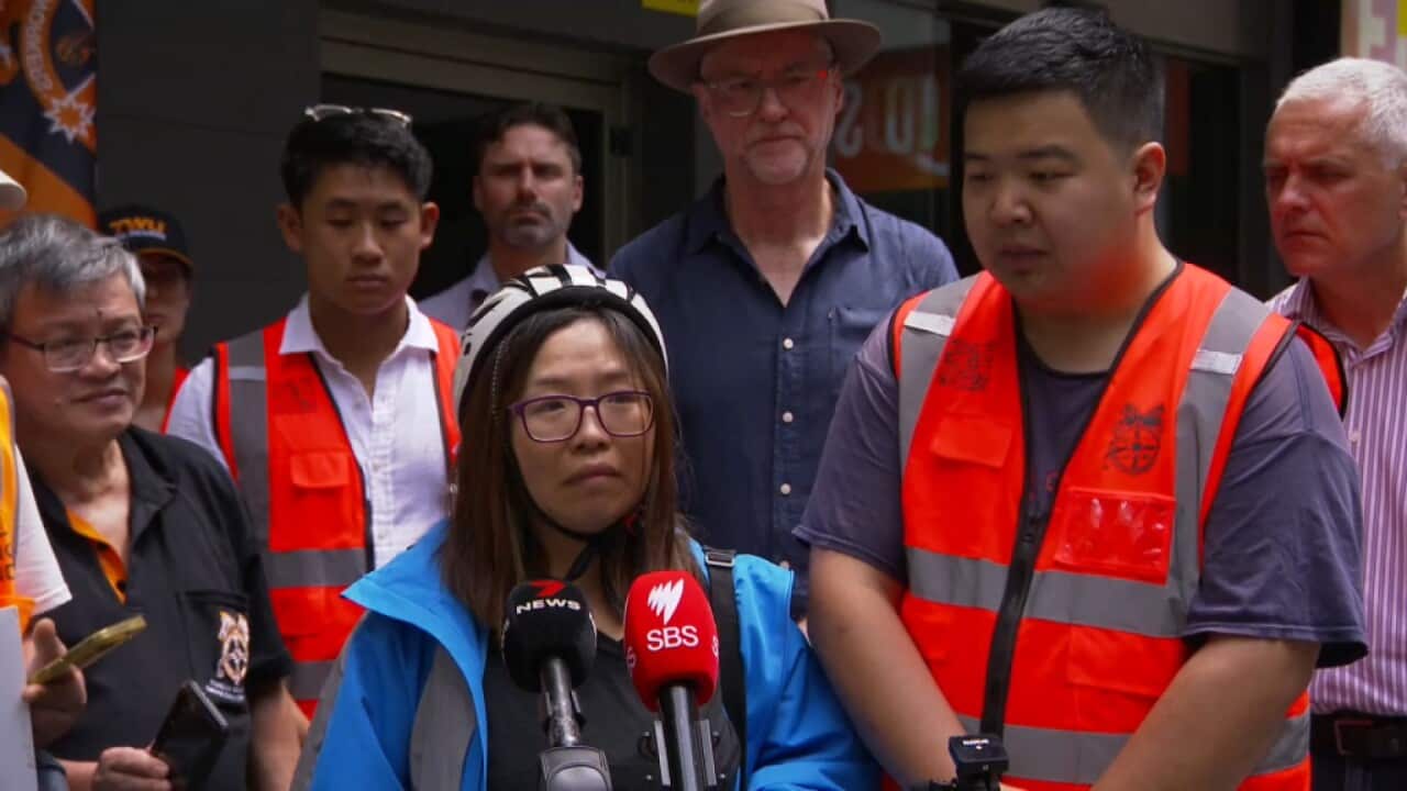 Hungry Panda food delivery service riders look distraught as they speak at a press conference in Sydney.jpg