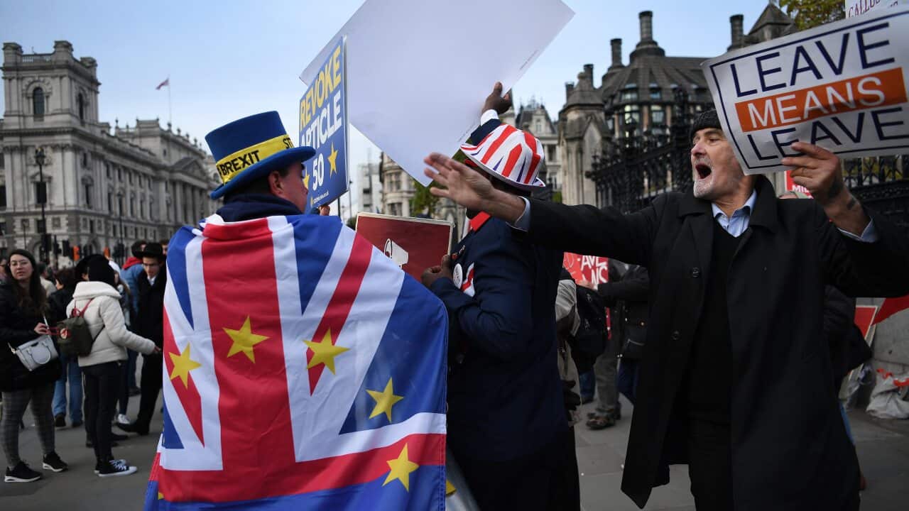 Pro-EU and pro-leave EU campaigners outside parliament in London.