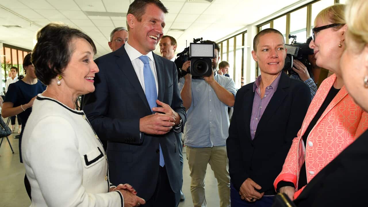 NSW Premier Mike Baird, along with minister for Prevention of Domestic Violence and Sexual Assault Pru Goward, (left), speaks with Moo Baulch, CEO of Domestic Violence NSW and Tracy Howe, CEO of the Council of Social Service of NSW, after announcing a $60