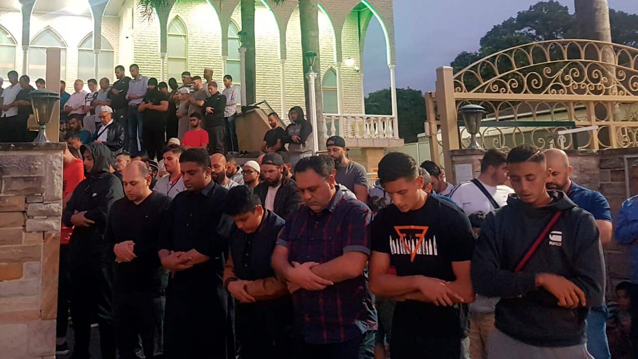 Worshipers pray for victims and families of the Christchurch shootings during an evening vigil a the Lakemba Mosque.