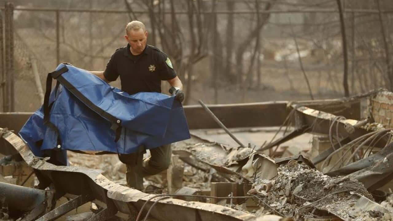 Search team member at a burned out home in Paradise, California