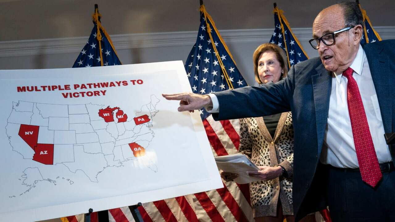 WASHINGTON, DC - NOVEMBER 19: Rudy Giuliani points to a map as he speaks to the press about various lawsuits related to the 2020 election, inside the Republican National Committee headquarters on November 19, 2020 in Washington, DC. President Donald Trump