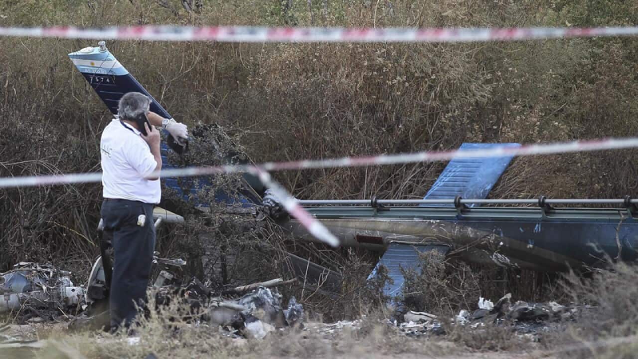 An expert inspects the site of a helicopter accident in Argentina