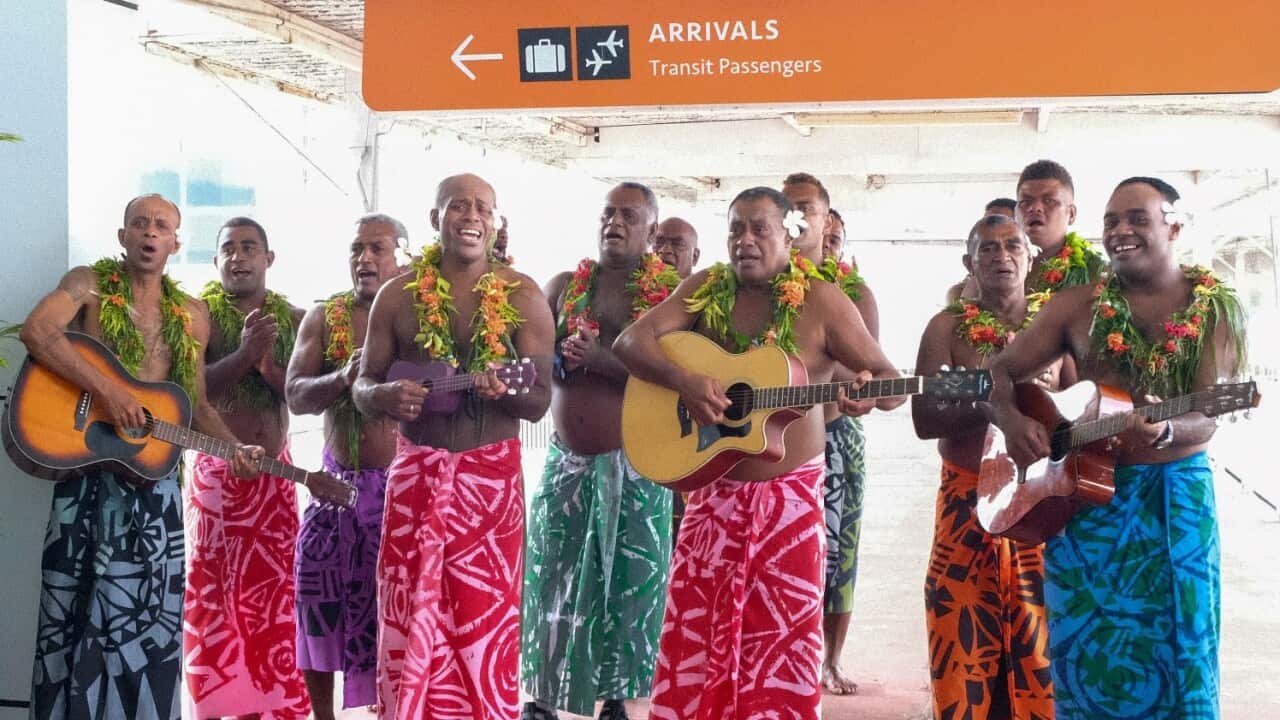Guests receive a traditional Fijian welcome as they arrive at Nadi International airport on 1 December 2021.