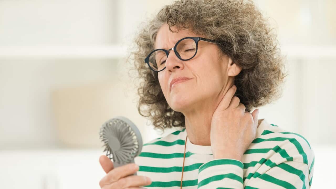 Menopausal woman having a hot flash