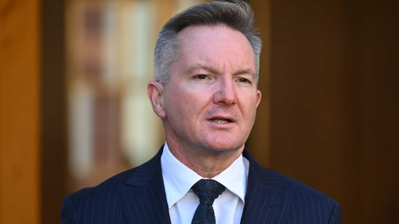 An middle aged white man wearing a navy suit