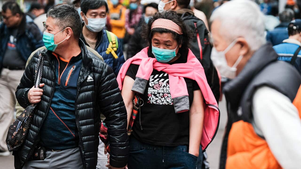 People wear surgical face mask on the street on 3 February in Hong Kong.
