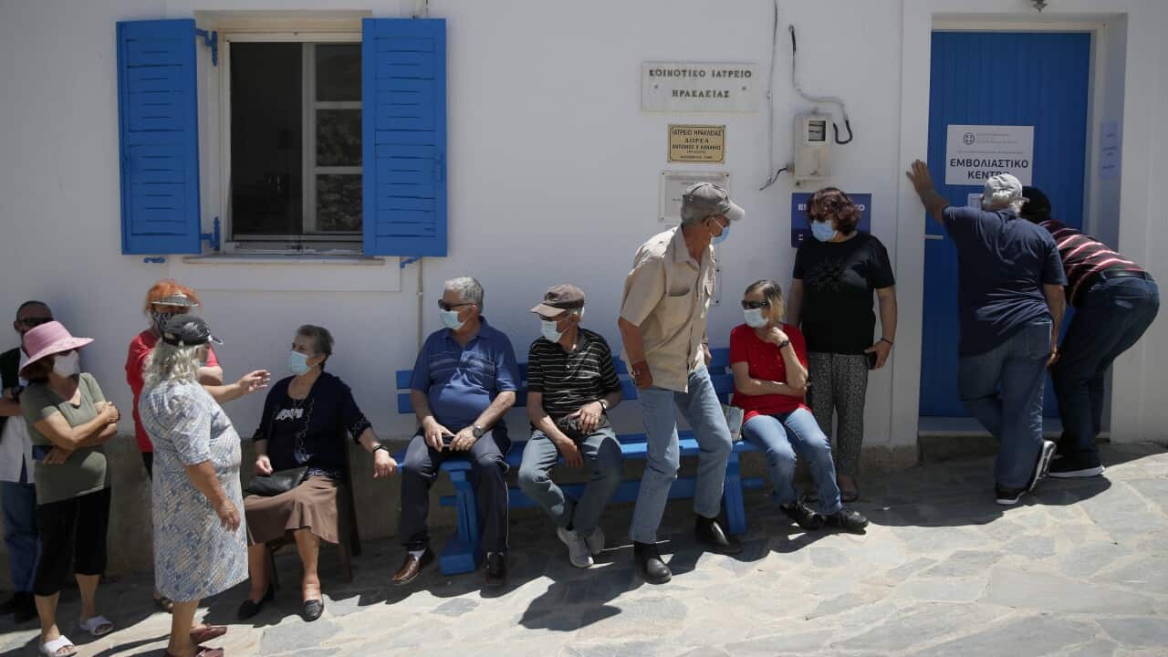Local residents wait for their second dose of the Pfizer vaccine against COVID-19 on the tiny Aegean island of Iraklia, Greece