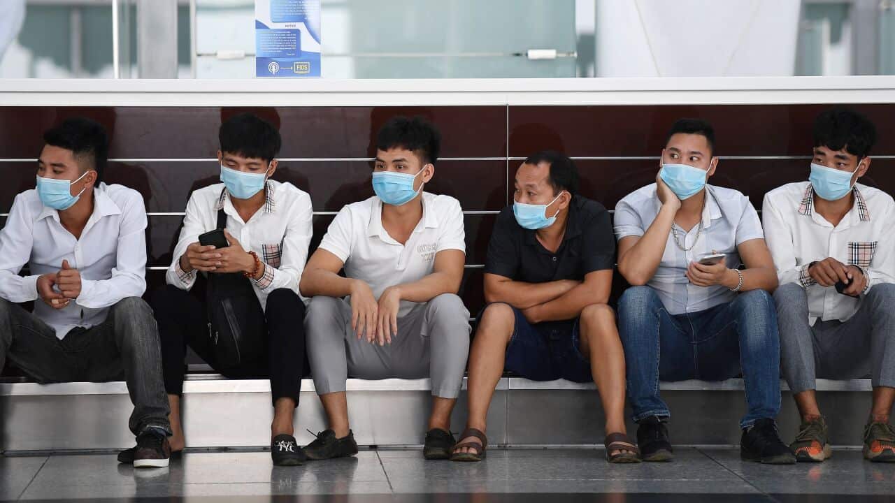 People wait inside the departure terminal at Noi Bai International Airport in Hanoi on 16 September, 2020