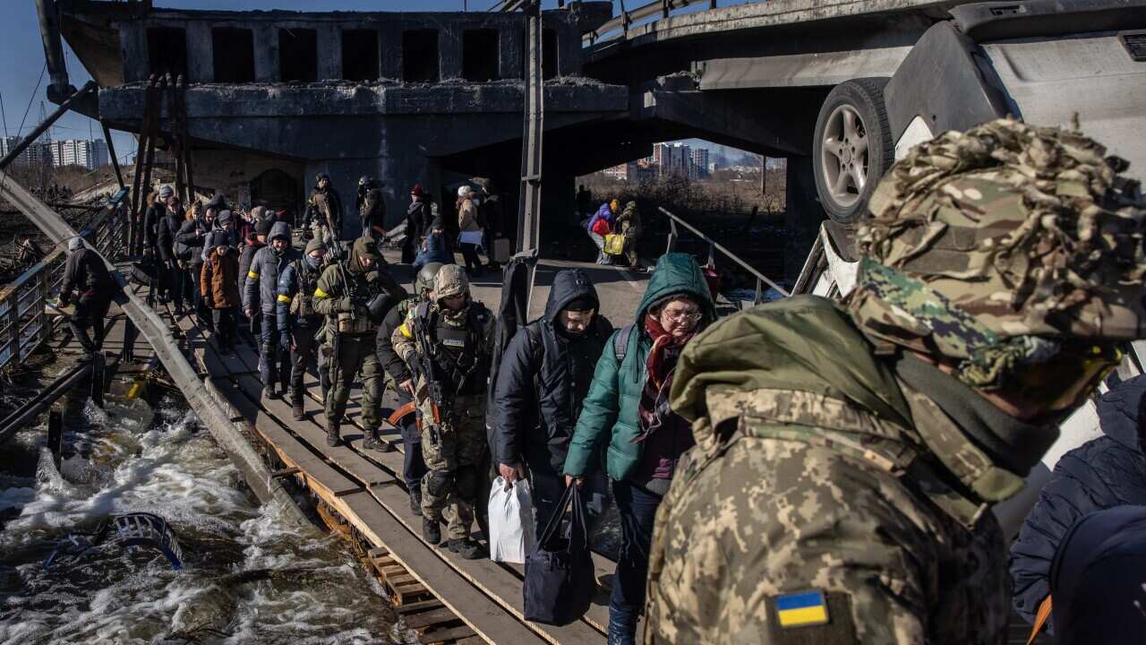 Residents of Irpin and Bucha, in the Kyiv region, are seen fleeing via a destroyed bridge