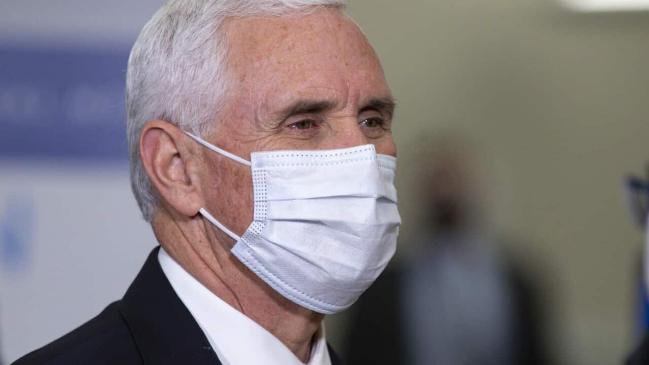 Vice President Mike Pence wears a mask as he visits the General Motors/Ventec ventilator production facility.