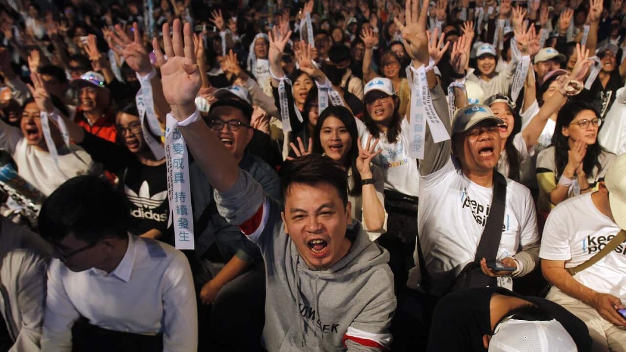 Supporters of Taipei city mayor and city mayoral candidate Ko Wen-je cheer in Taipei, Taiwan, Saturday. 