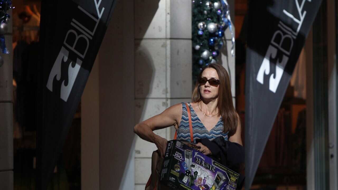 A woman leaves the Pitt Street mall with shopping bags in Sydney