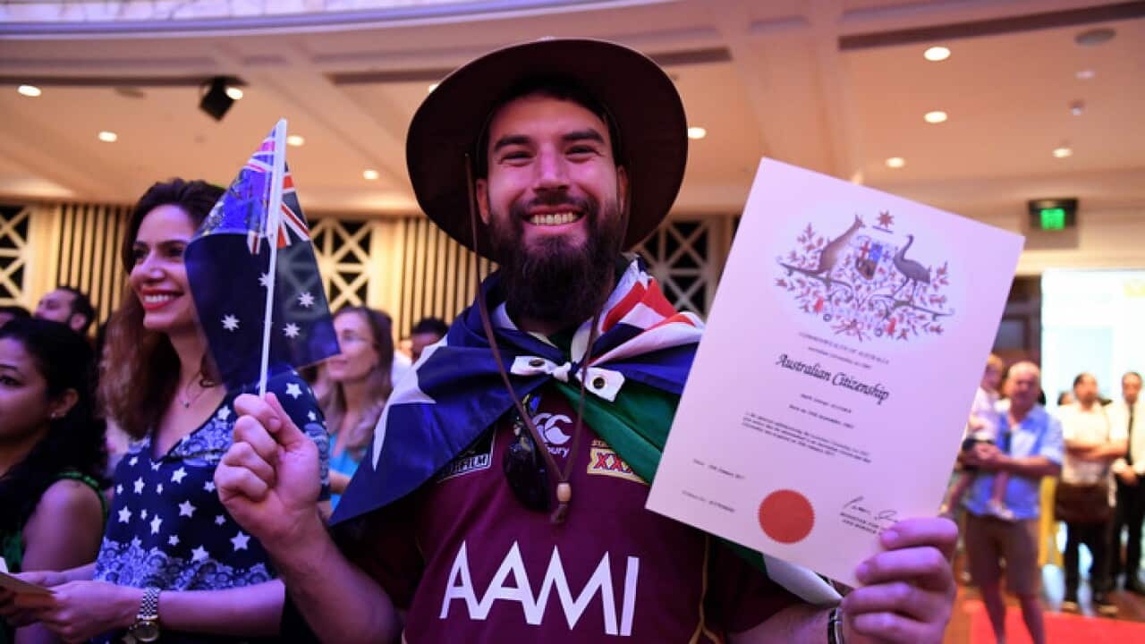 Mark Alcorn of Ireland celebrates receiving his Australian citizenship at a citizenship ceremony on Australia Day in Brisbane, Thursday, Jan. 26, 2017. (AAP Image/Dan Peled) NO ARCHIVING