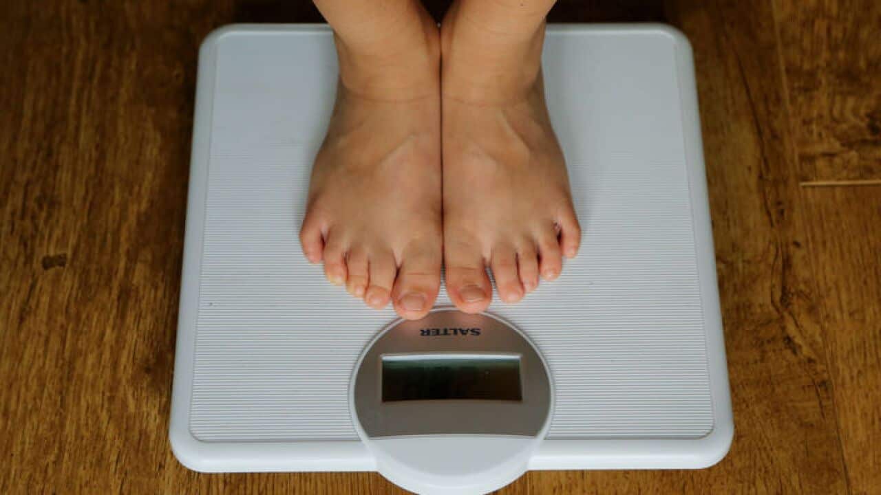 Achild being weighed on scales