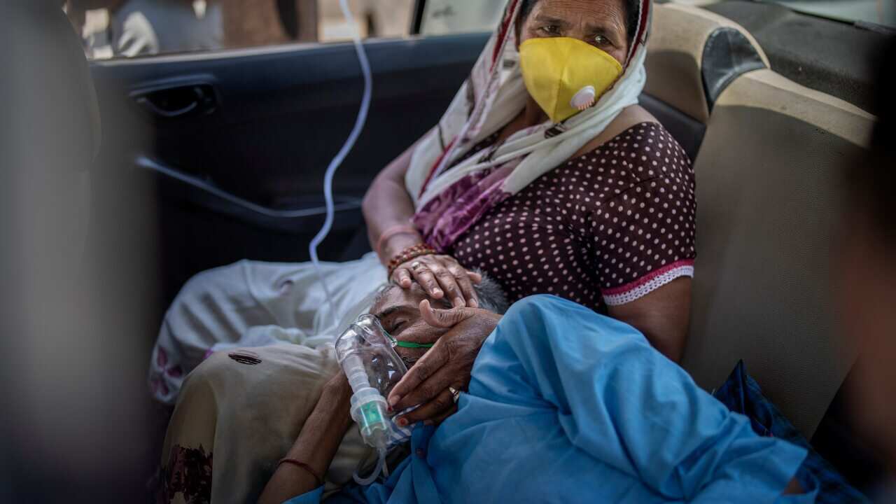 A patient breathes with the help of oxygen provided by a Gurdwara, Sikh place of worship, inside a car in New Delhi, India, Saturday, 24 April, 2021.