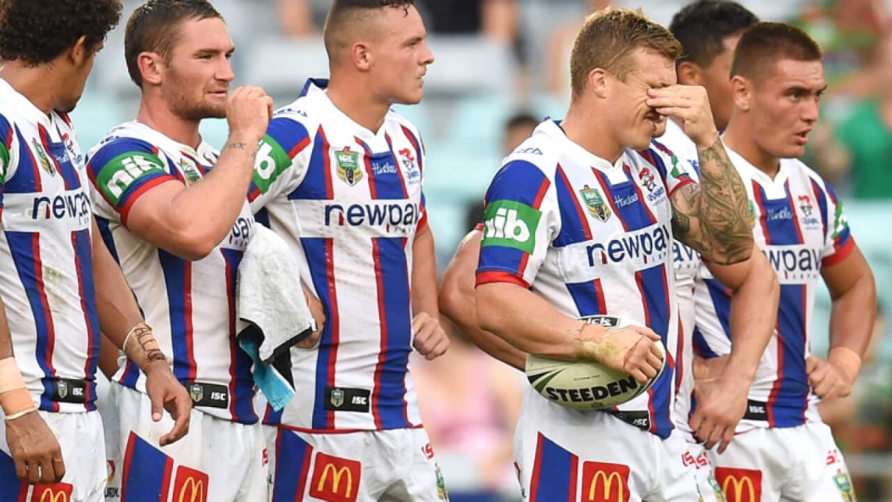 Trent Hodkinson (2R) of the Knights reacts