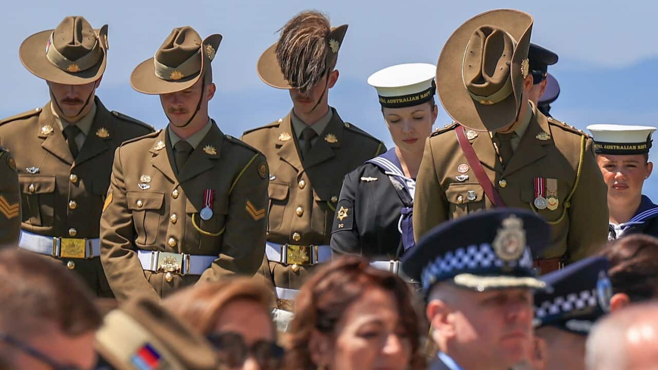Australian and New Zealand soldiers pay their respects during a Anzac Day ceremony.