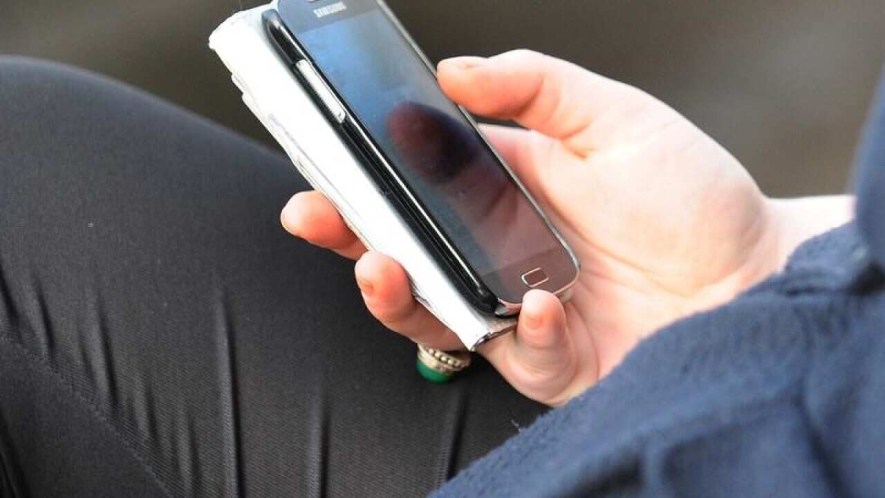 File photo dated 11/10/14 of a person using a mobile phone.