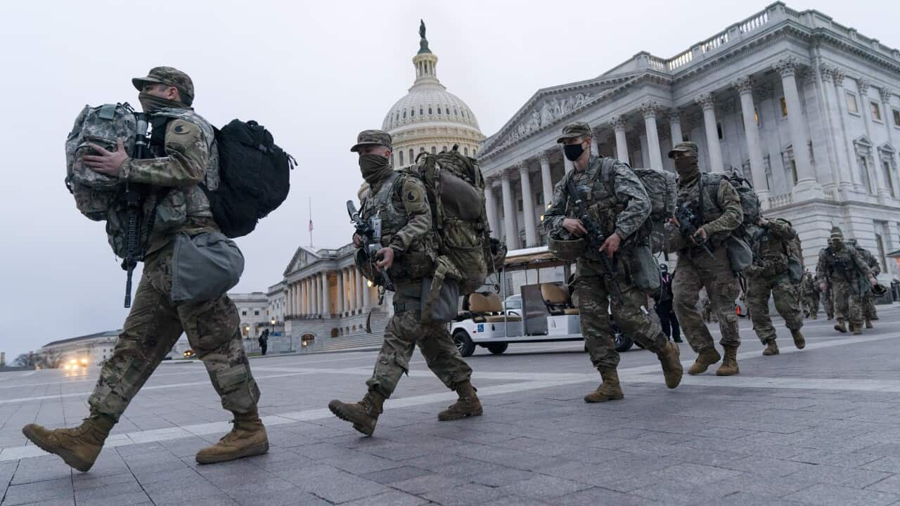 National Guard soldiers walk out of the U.S. Capitol, Saturday, Jan. 16, 2021, in Washington, as security is increased ahead of the inauguration of President-elect Joe Biden and Vice President-elect Kamala Harris