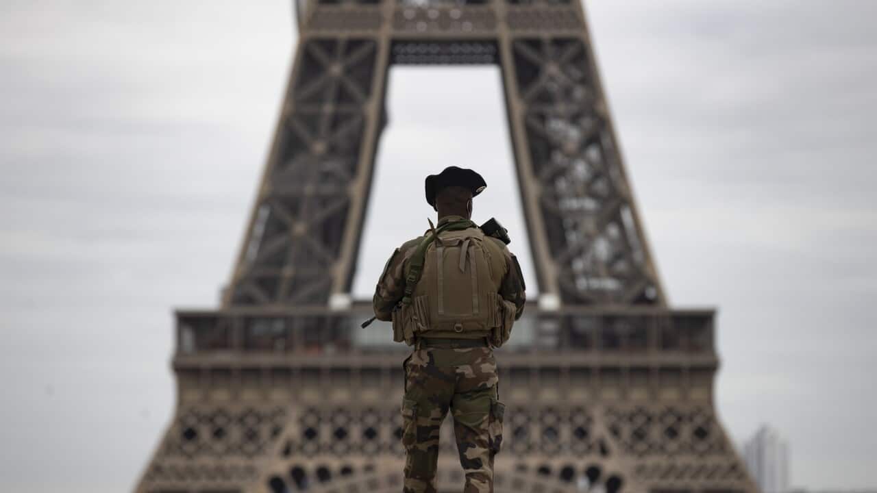 A French soldier patrols the deserted Trocadero square near the Eiffel Tower in Paris