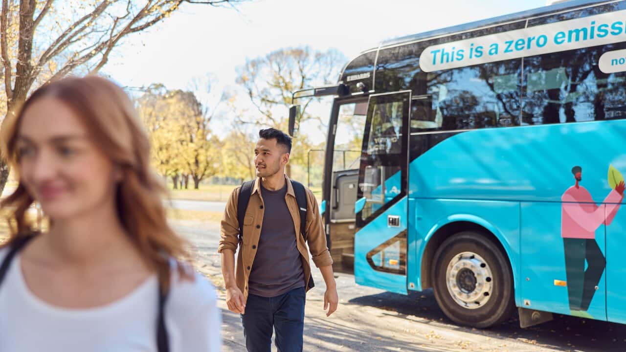 Passengers getting off Zero Emissions bus at bus stop at the University of New England in Armidale, 2024