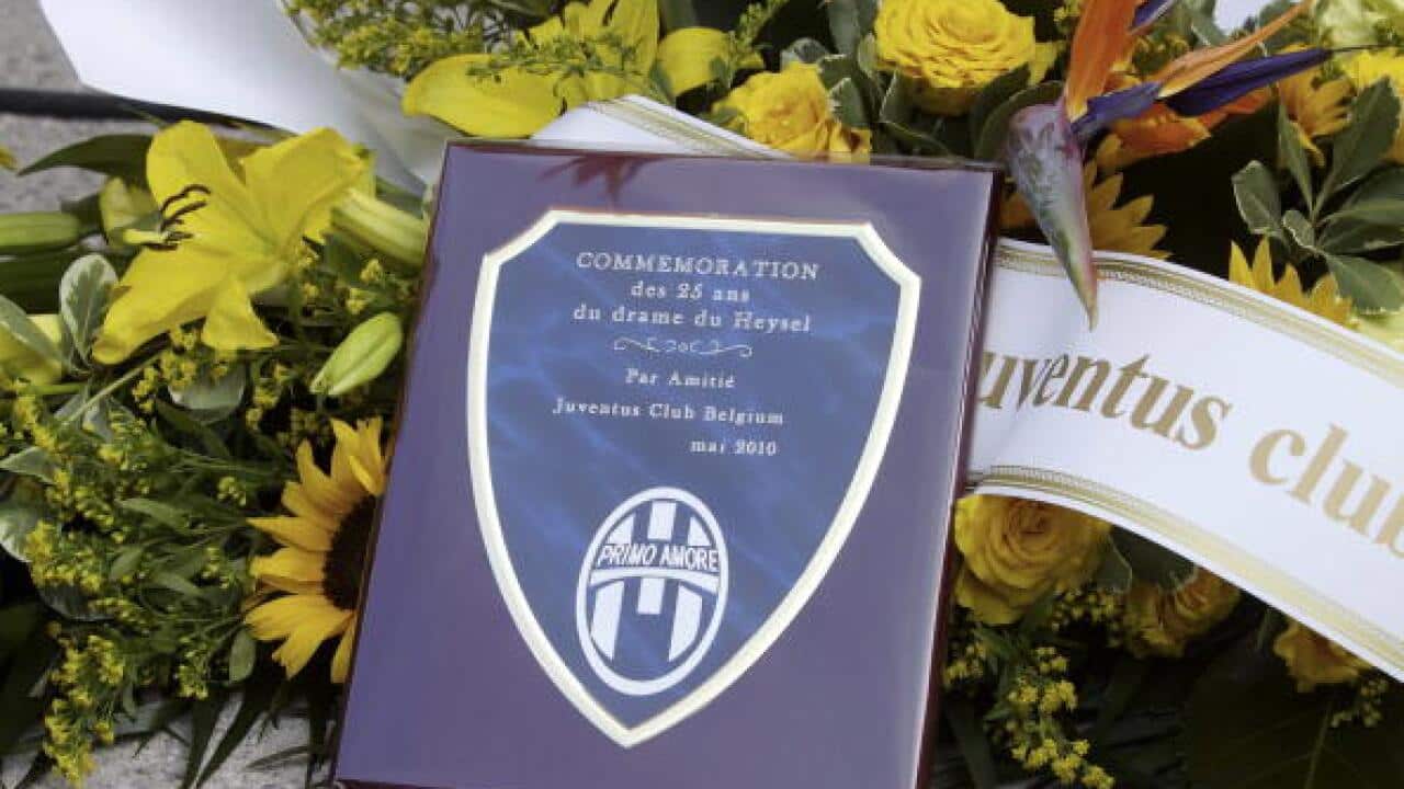 A commemoration book lies surrounded by