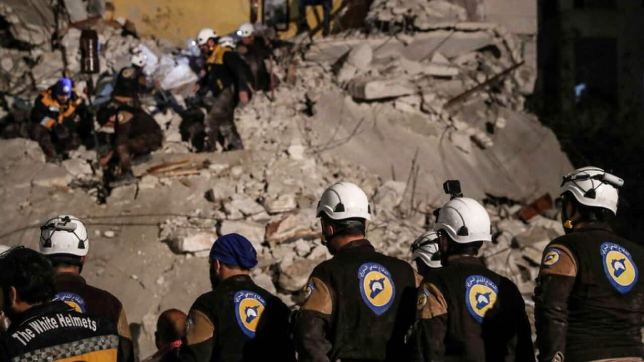 White Helmets volunteers search for survivors after an explosion in the city of Idlib, Syria, in April