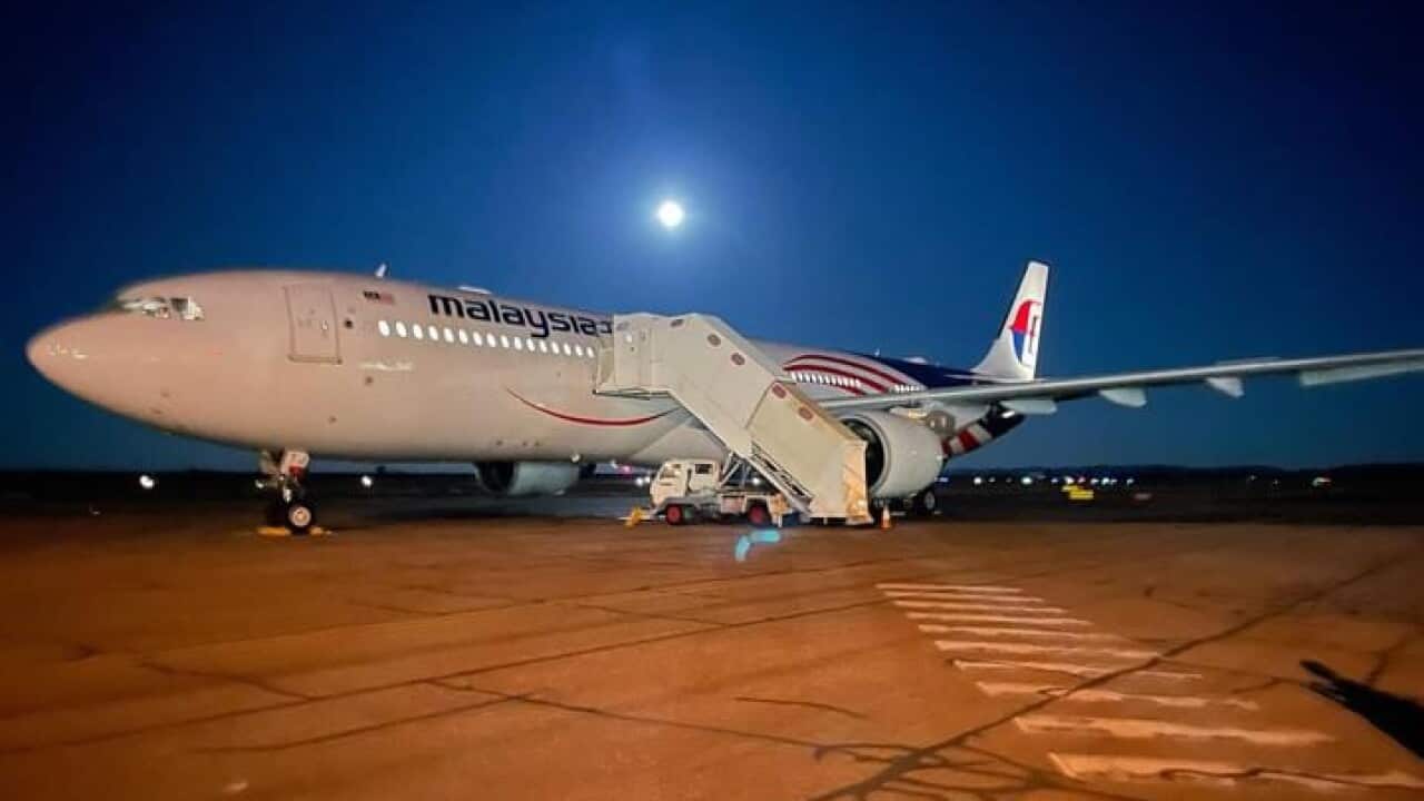 A Malaysia Airlines plane parked on the tarmac.