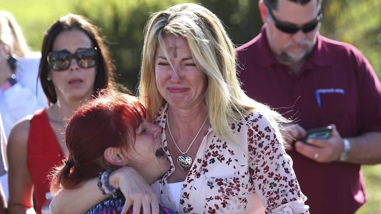 Parents wait for news after a reports of a shooting at Marjory Stoneman Douglas High School in Parkland, Florida.