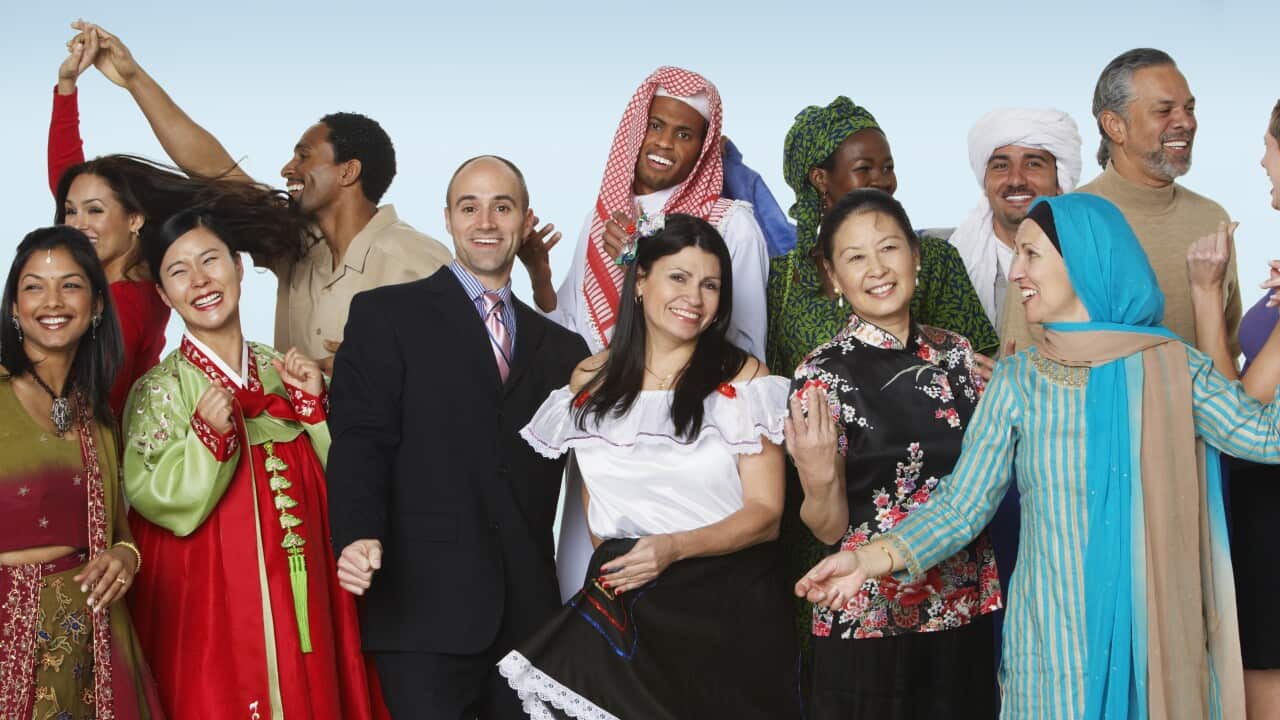 Multi-ethnic people in traditional dress dancing