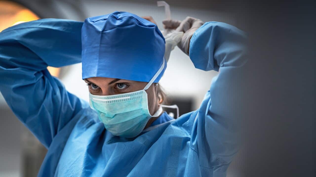 The surgeon is wearing a mask to prevent infection before surgery.