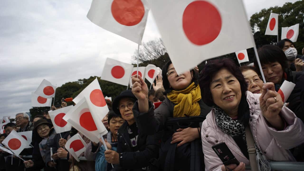 Well-wishers wave Japanese for Emperor Akihito's 80th birthday